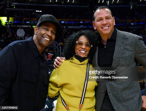 Denzel Washington and his wife Pauletta pose with Alex Rodriguez as they attend a basketball game between the Minnesota Timberwolves and Los Angeles...