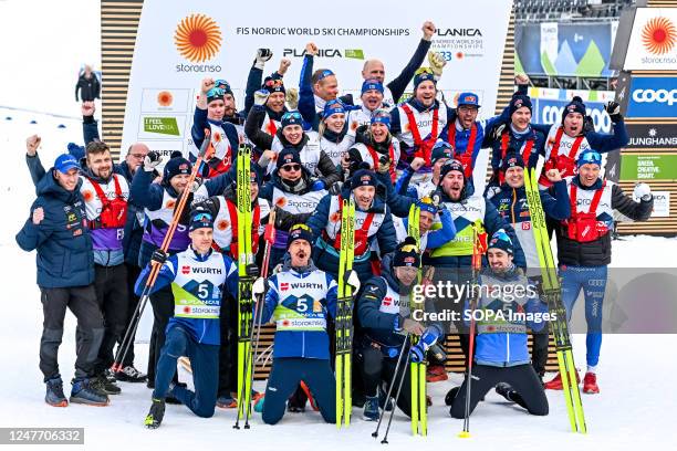 Members of team Finland with their whole team celebrate their second place during the Cross Country Men Relay 4x10 km competition at the FIS Nordic...