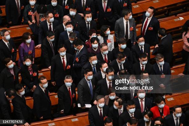 Delegates leave after the opening ceremony of the Chinese People's Political Consultative Conference at the Great Hall of the People in Beijing on...