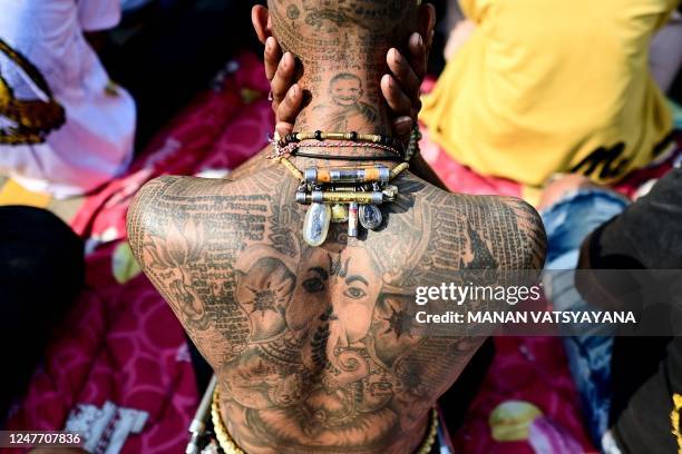 Buddhist devotee with traditional "Sak Yant" tattoos takes part in an annual sacred tattoo festival at the Wat Bang Phra temple in Nakhon Pathom...