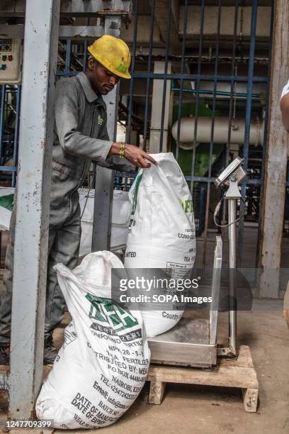 Worker operates a precision weighing machine at the Fertiplant fertilizer granulation factory in Nakuru. Fertiplant, a local fertilizer plant, is...