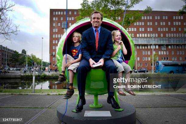Lawyer Robert F. Kennedy Jr. And his children sit in a globe at the exhibition of Cool Globes in Amsterdam on June 7, 2011. The exhibition features...