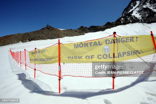 Picture taken on June 30, 2011 shows a security barrier warning of a possible collapse of a 30 to 40 meters thick ice sheet at the Tete Rousse...