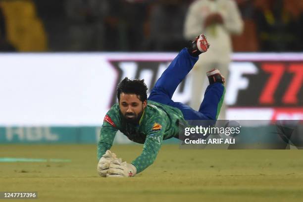 Multan Sultans' Mohammad Rizwan takes a catch of Lahore Qalandars' Mirza Baig during the Pakistan Super League Twenty20 cricket match between Multan...