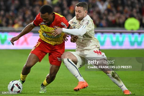 Lens' Belgian forward Lois Openda vies with Lille's Swedish defender Gabriel Gudmundsson during the French L1 football match between Lens and Lille...