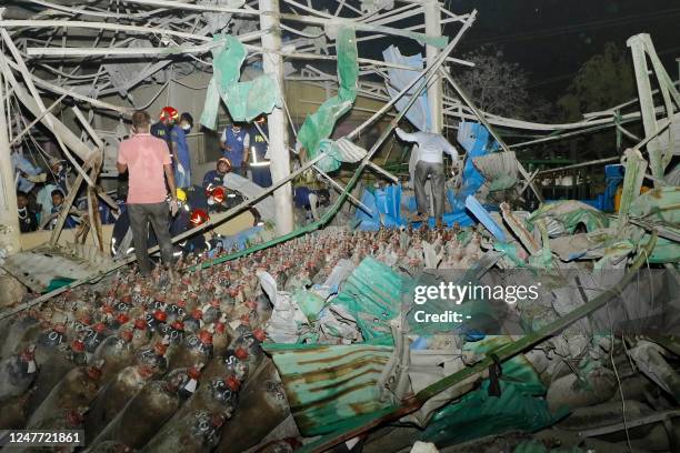 Firefighters and rescue workers gather at the site of an explosion at an oxygen plant on the outskirts of Chittagong on March 4, 2023. - At least...