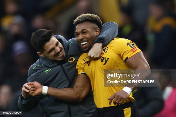 Wolverhampton Wanderers' Spanish midfielder Adama Traore is congratulated by teammates at the end of the English Premier League football match...