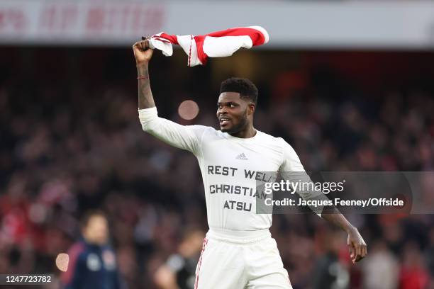 Thomas Partey of Arsenal celebrates victory with a shirt that has a tribute to Christian Atsu who recently passed away during the Premier League...