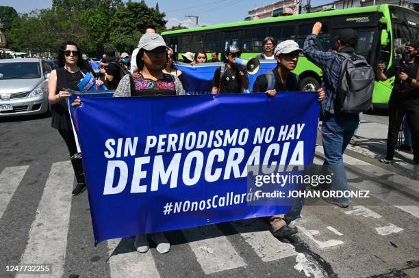 Journalists and members of the Guatemalan Civil Society carry a banner reading "Without Journalism There is No Democracy" during a demonstration...