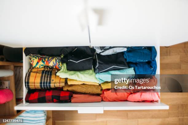 colorful shirts in a white drawer - closet shelf of colorful folded clothes stockfoto's en -beelden