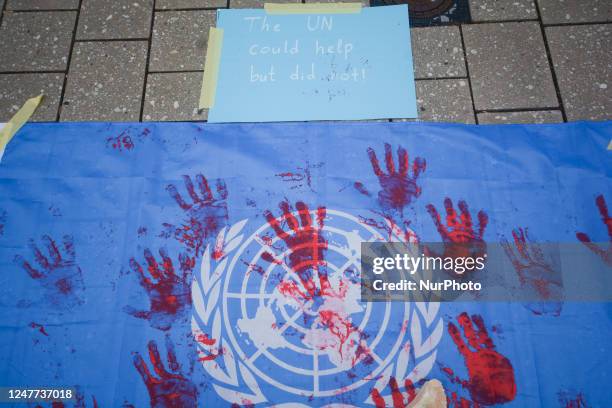 Flag painted with bloody handprints is seen in front of the United Nations Square in Bonn, Germany on March 4 demanding immediate support for...