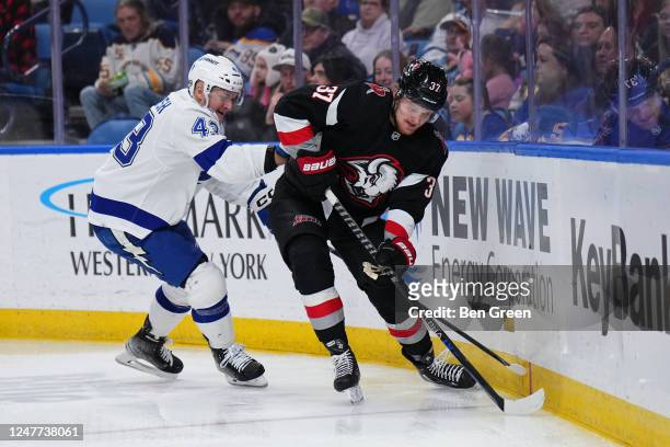 Casey Mittelstadt of the Buffalo Sabres controls the puck against Darren Raddysh of the Tampa Bay Lightning during an NHL game on March 4, 2023 at...