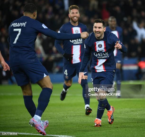 Paris Saint-Germain's Argentine forward Lionel Messi celebrates with Paris Saint-Germain's French forward Kylian Mbappe after scoring a goal during...