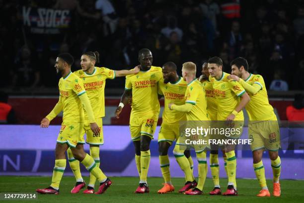 Nantes' Cameroonian forward Igniatus Ganago is congratulated by team mates after scoring a goal during the French L1 football match between Paris...