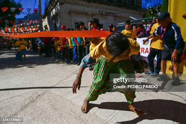 Raramuri girl arrives at the finish line during the first day of activities of the ultra marathon "Caballo Blanco" in Urique , Chihuahua state,...