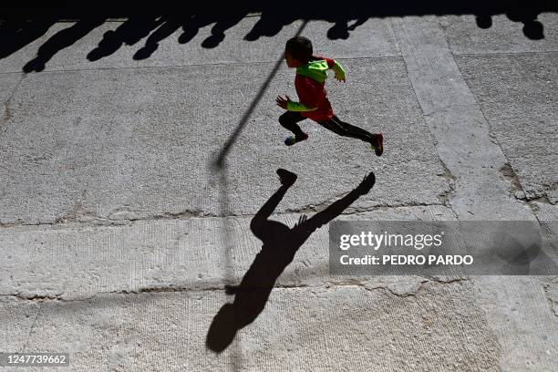 Raramuri boy competes in a short race during the first day of activities of the ultra marathon "Caballo Blanco" in Urique, Chihuahua state, Mexico,...