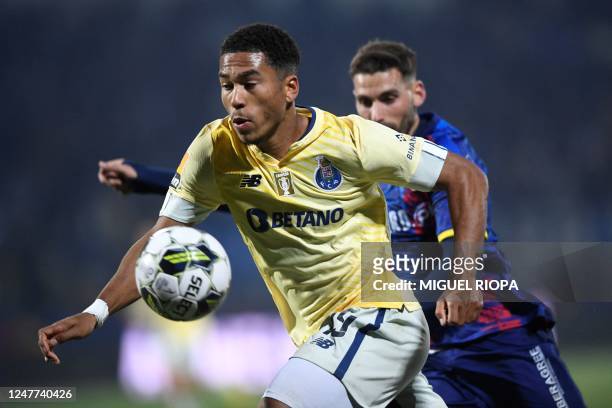 Porto's British forward Danny Namaso Loader vies with Chaves' Portuguese midfielder Guima during the Portuguese League football match between GD...