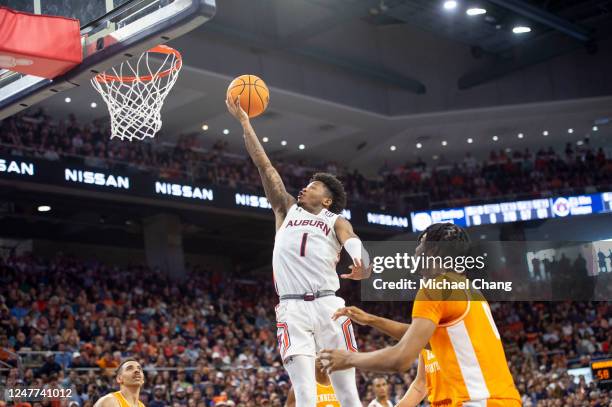 Wendell Green Jr. #1 of the Auburn Tigers attempts a layup in front of Jonas Aidoo of the Tennessee Volunteers and Olivier Nkamhoua of the Tennessee...