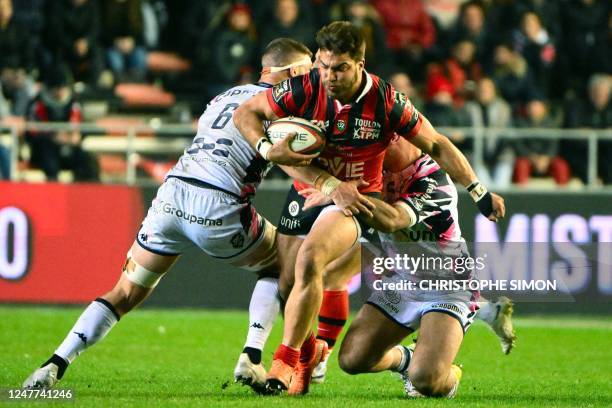 Toulon's Argentinian number 8 Facundo Isa is tackled during to the French Top 14 rugby union match between Rugby Club Toulonnais and Stade Francais...