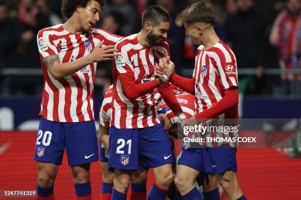 Atletico Madrid's Belgian midfielder Yannick Ferreira-Carrasco celebrates scoring his team's fourth goal with teammates during the Spanish League...