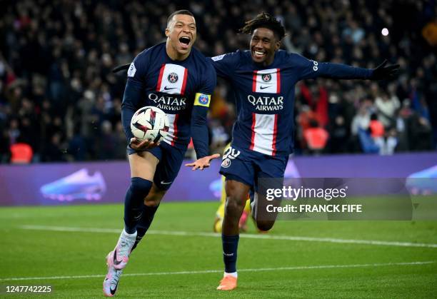 Paris Saint-Germain's French forward Kylian Mbappe celebrates with Paris Saint-Germain's French defender Timothee Pembele after he scored a goal...