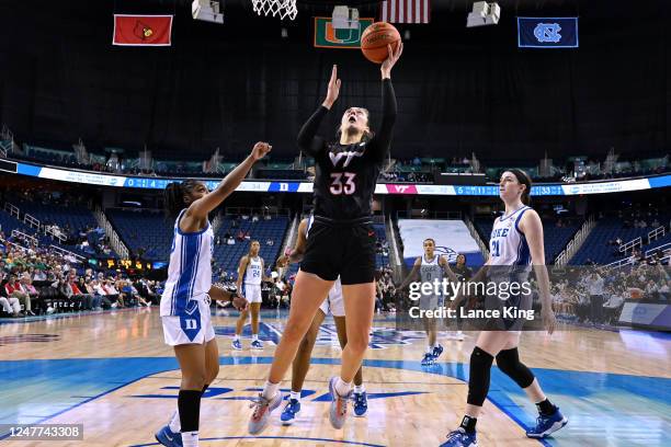 Elizabeth Kitley of the Virginia Tech Hokies puts up a shot against Shayeann Day-Wilson of the Duke Blue Devils during the second half of their game...