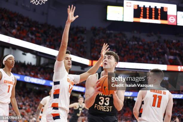 Matthew Marsh of the Wake Forest Demon Deacons looks for a shot past Jesse Edwards of the Syracuse Orange during the game at JMA Wireless Dome on...