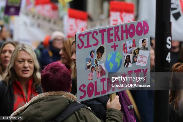 Woman holds a placard during the Million Women Rise protest in central London ahead of International Womens Day on March 8 to end male violence...