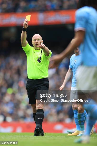 Referee Simon Hooper points an accusing finger as he shows the yellow card during the Premier League match between Manchester City and Newcastle...