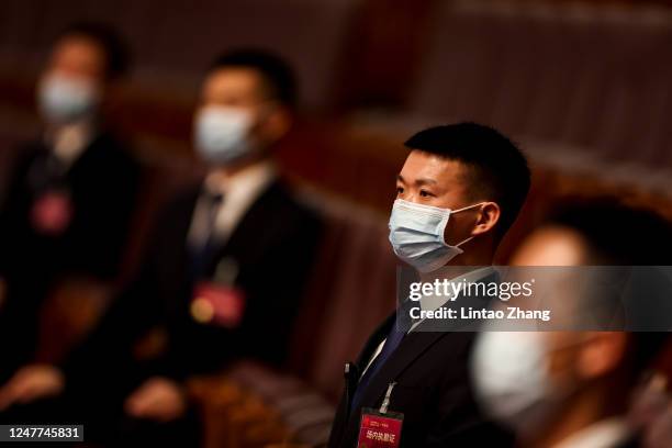 Security personnel sit inside the Great Hall of the People ahead of the opening of the China's Leadership Holds Annual Two Sessions Political...