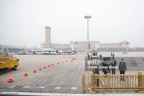 Security personnel stand guard at Tiananmen Square during the opening session of the National People's Congress on March 5, 2023 in Beijing,...