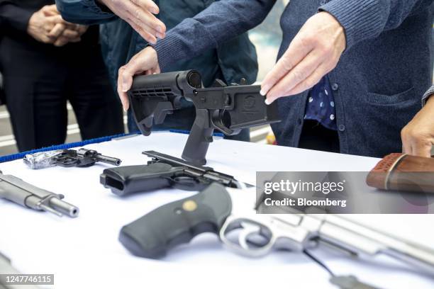Bump stock and handguns collected during a buyback event in the Wilmington neighborhood of Los Angeles, California, US, on Saturday, March 4, 2023....
