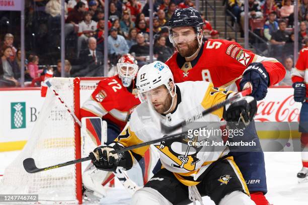Aaron Ekblad of the Florida Panthers defends against Bryan Rust of the Pittsburgh Penguins during second-period action at the FLA Live Arena on March...