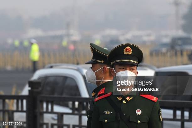 Paramilitary police officers stand guard south of the Great Hall of the People before the opening session of the National Peoples Congress in Beijing...
