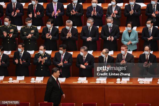 Chinese President Xi Jinping, and other government and official stand during the opening session of the National People's Congress at the Great Hall...