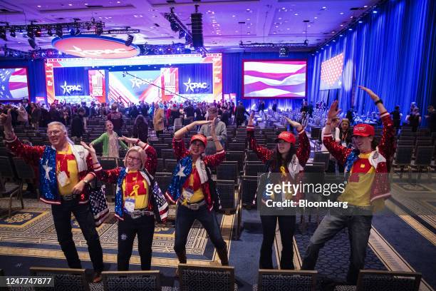 Supporters of former US President Donald Trump dance during the Conservative Political Action Conference in National Harbor, Maryland, US, on...