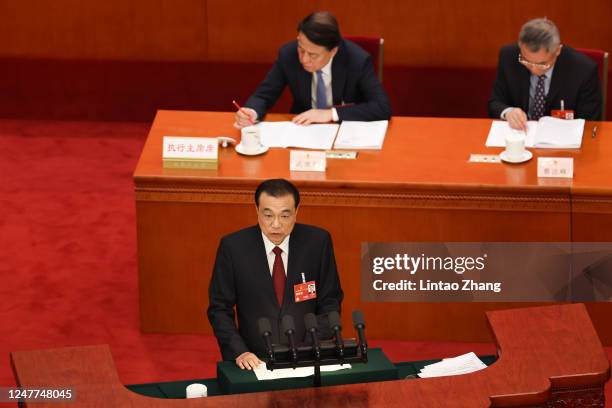 Chinese Premier Li Keqiang delivers a speech during the opening of the first session of the 14th National People's Congress at The Great Hall of...