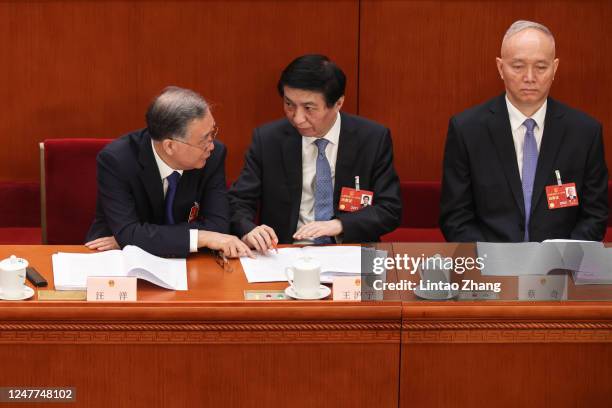 Delegates Wang Yang,Wang Huning,Cai Qi attend during the opening of the first session of the 14th National People's Congress at The Great Hall of...