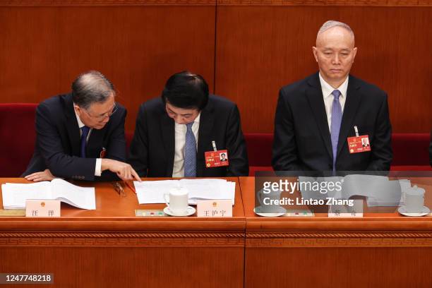 Delegates Wang Yang,Wang Huning,Cai Qi attend during the opening of the first session of the 14th National People's Congress at The Great Hall of...
