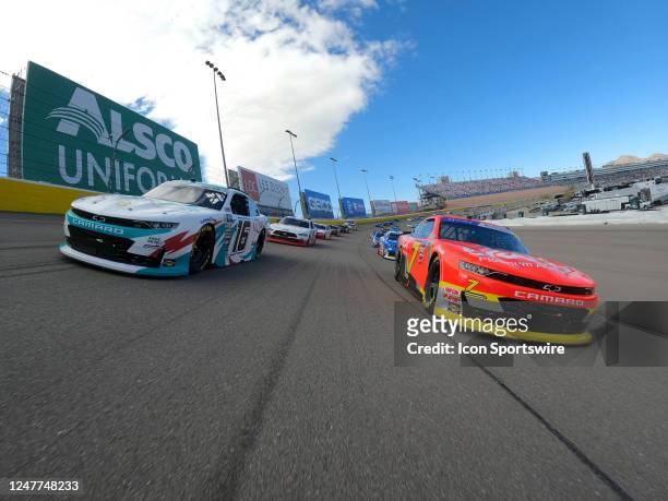 Chandler Smith and Justin Allgaier lead the field under the Alsco Uniforms billboard for the final pace lap before the start of the race during the...