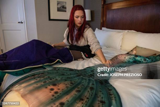 Helena McLeod inspects her mermaid silicone tail after unpacking it in her room and after it being rolled up for the car ride to the hotel at the...