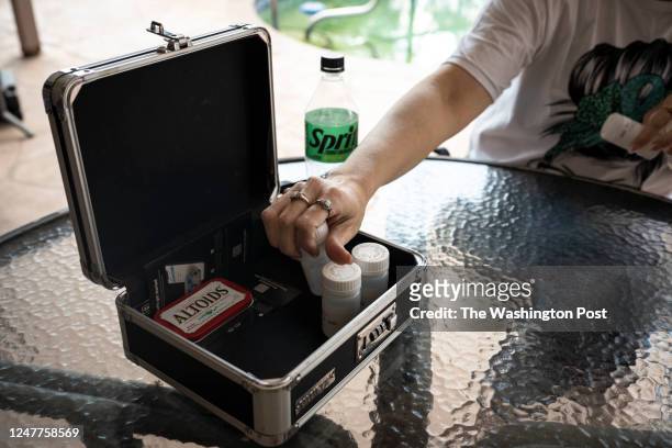 Former heroin addict Krystal Parker places doses of methadone back into a box she can lock in Punta Gorda, Fla. On Tuesday February 28, 2023. Parker...