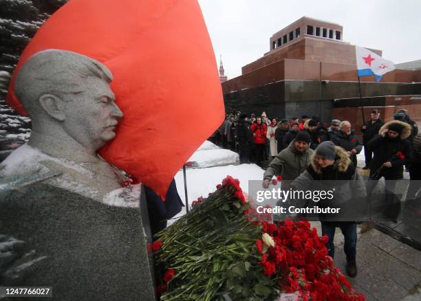 Man puts flowers at former Soviet leader Joseph Stalin's grave at Red Square near the Kremlin, during ceremony, marking the 70th Anniversary of...