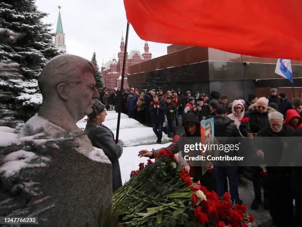 Man puts flowers at former Soviet leader Joseph Stalin's grave, at Red Square near the Kremlin, during ceremony, marking the 70th Anniversary of...