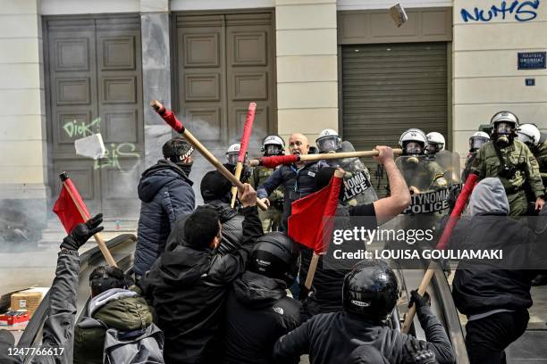 Protesters clash with riot police at the entrance of a metro station during a demonstration in Athens on March 5 following a deadly train accident...