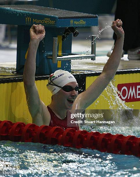 August 3: Rebecca Cooke of England celebrates gold in the Women's 400M Freestyle swimming Final from the Manchester Aquatics centre during the 2002...