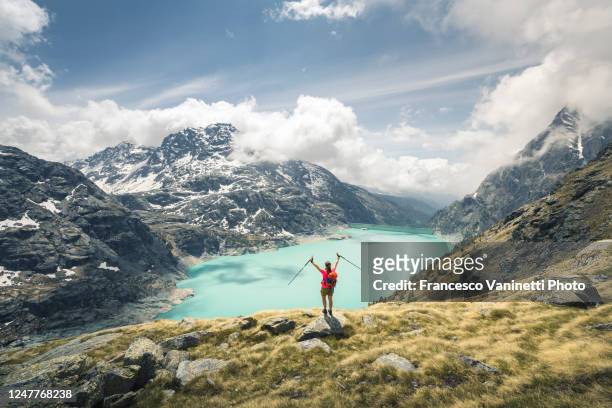 woman raising arms on top of the mountain in valmalenco, italy. - in touch with nature stock pictures, royalty-free photos & images