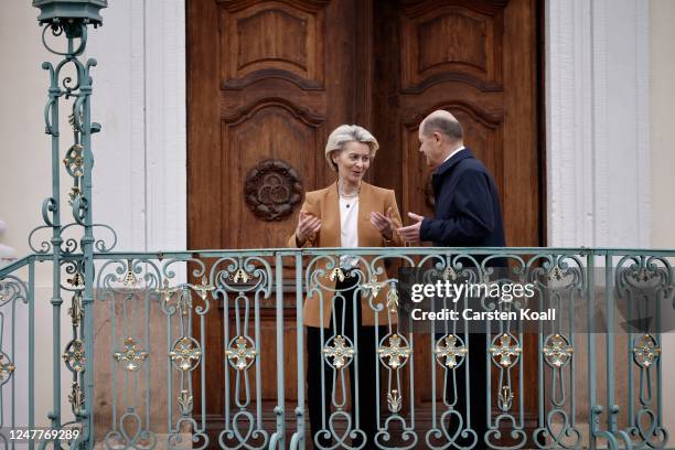 German Chancellor Olaf Scholz greets European Commission President Ursula von der Leyen during a retreat of the German government cabinet at Schloss...