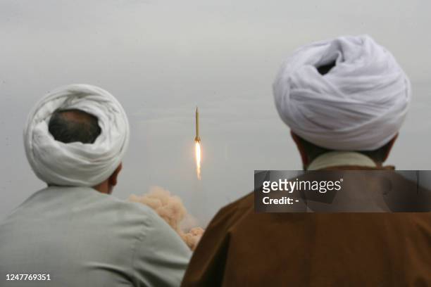 Iranian clergymen watch a Shahab-3 long-range ballistic missile fird by Iran's Revolutionary Guards in the desert outside the holy city of Qom, 02...