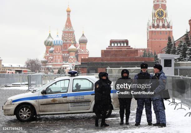 Russian Police officers stand by their Renault Logan as they guard during the ceremony, hosted by the Communist Party, marking the 70th Anniversary...